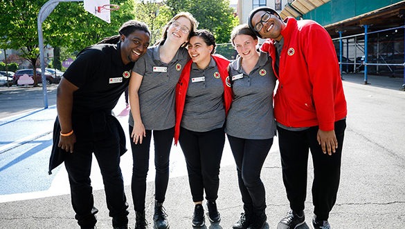 Group of five ɫƵ AmeriCorps members arm in arm smiling at the camera